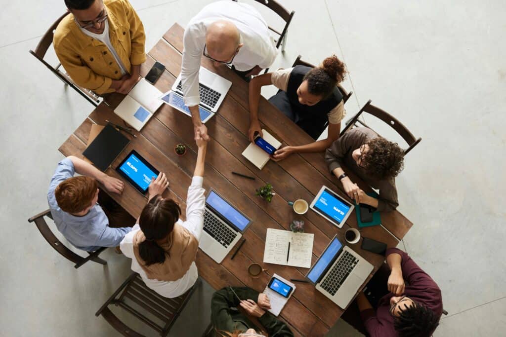Employees gathered around a table, reflecting industry-expertise